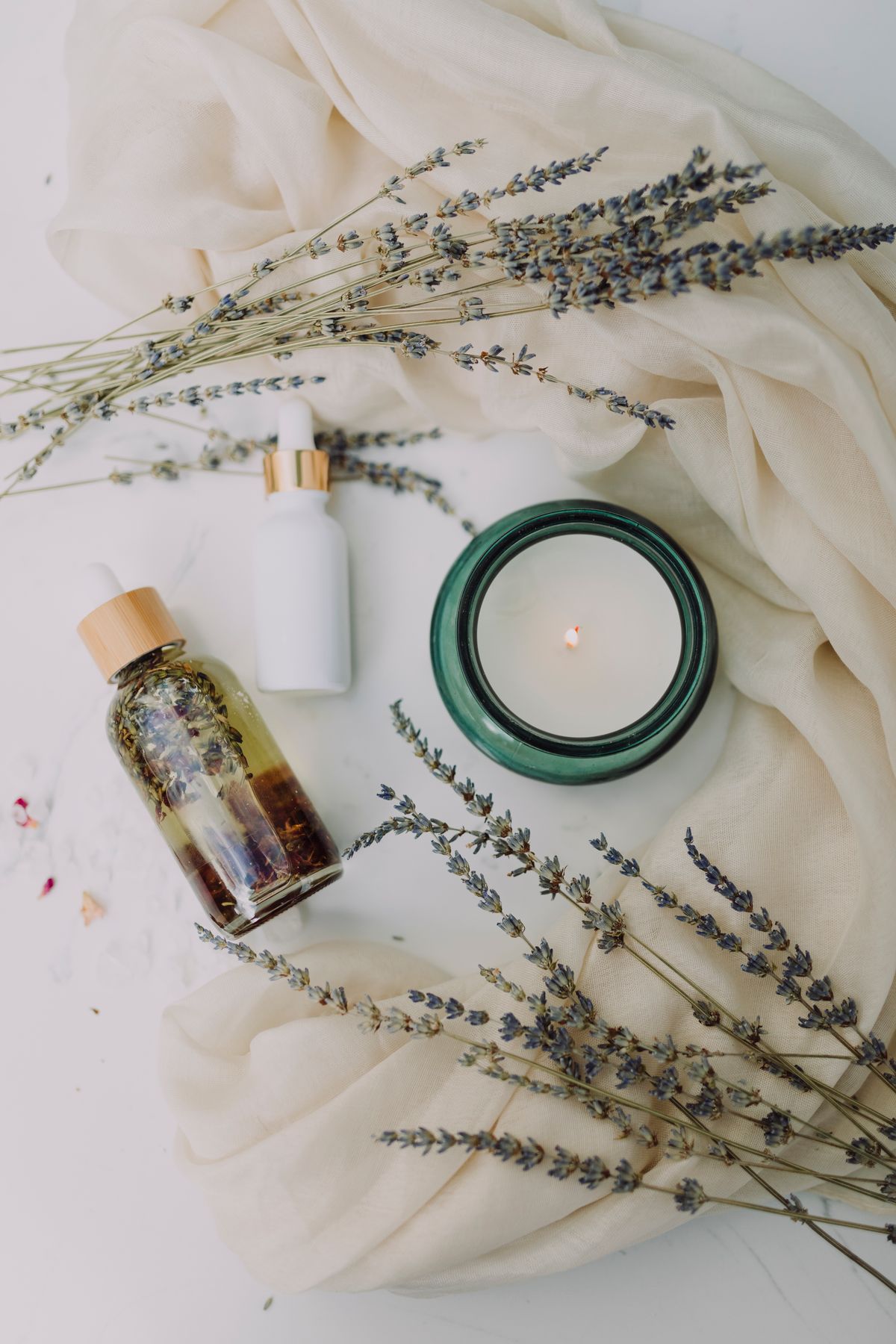 Spa ambiance with candle and essential oils